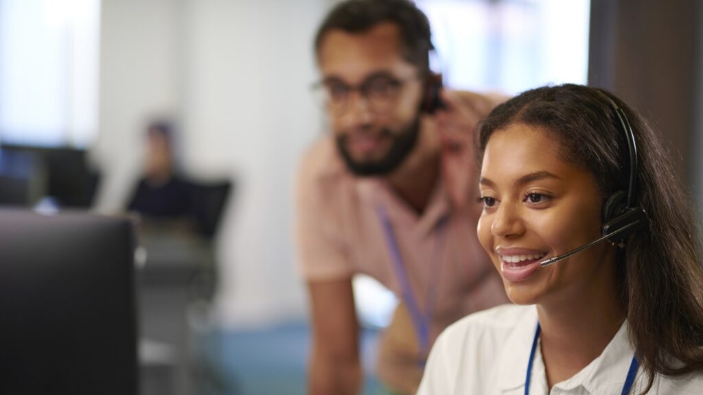 Female office worker smiling while talking on headset
